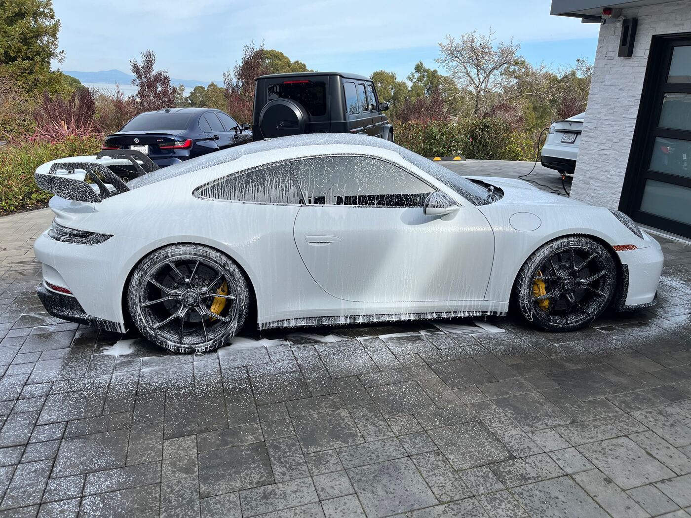 White Porsche 911 GT3 covered in wash foam